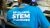 BP Global STEM Academy student wearing a STEM academy t-shirt sitting at a desk