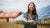  Woman stands in front of a solar farm 