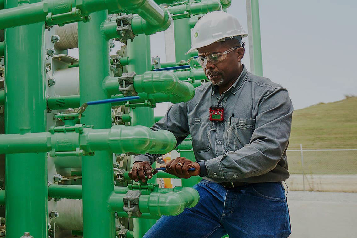 Engineer works on outdoor pipes