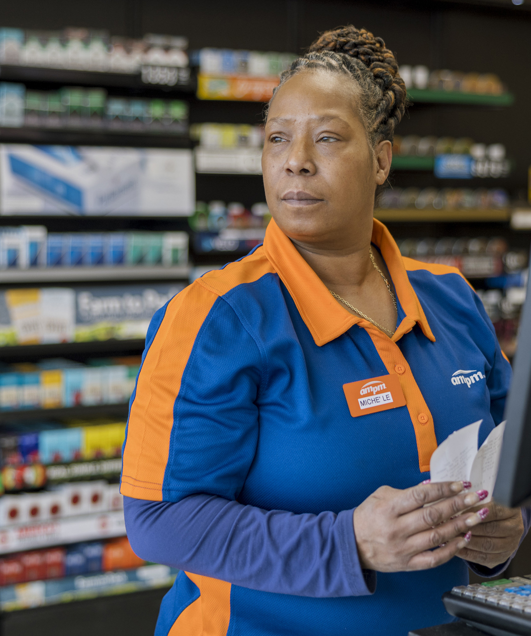 Employee working at the New York ampm store