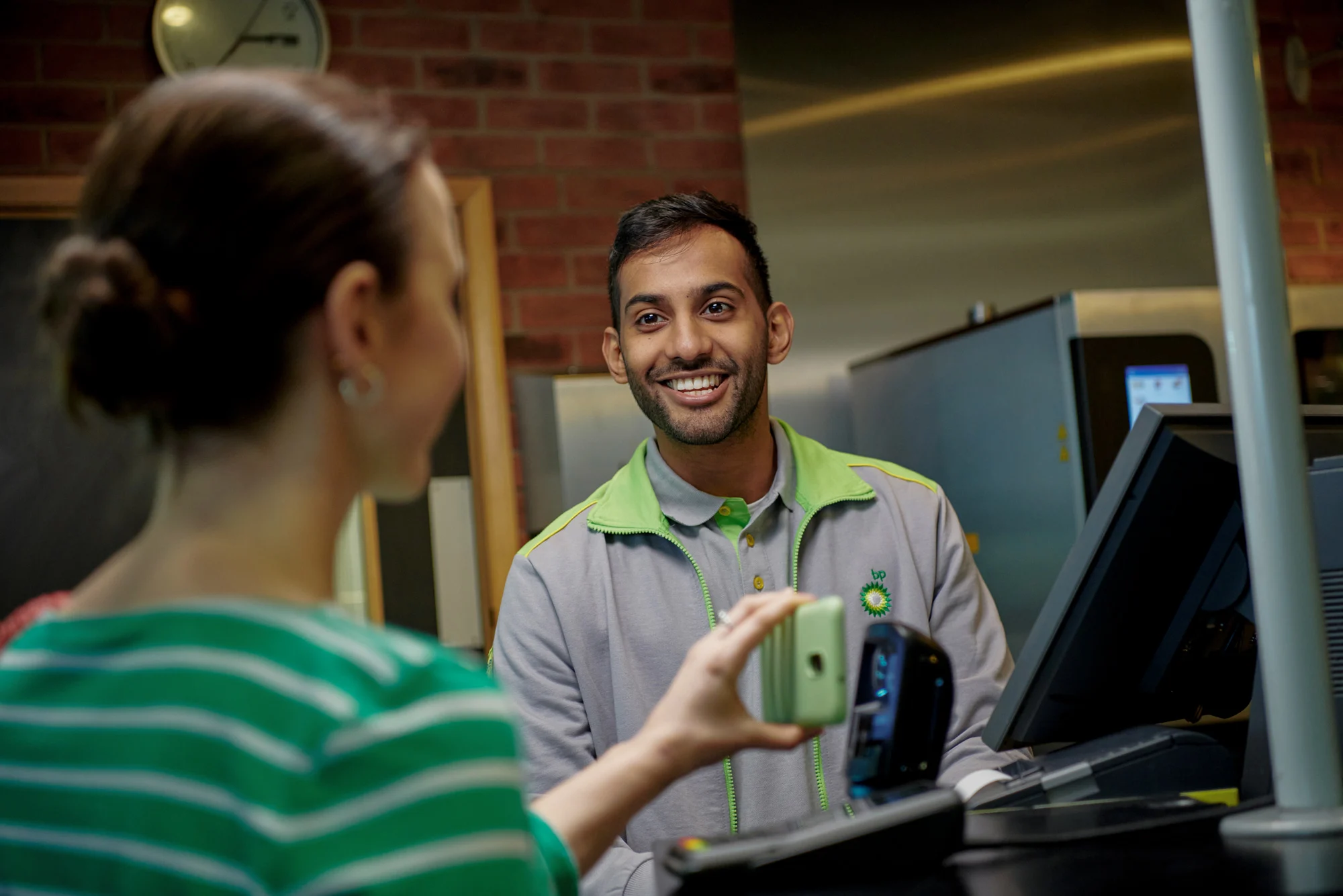 A customer visiting a M&S Food store at a bp retail station